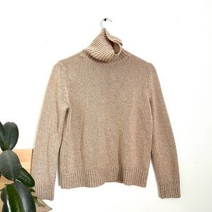 Beige colored turtleneck, sweater with button detail
